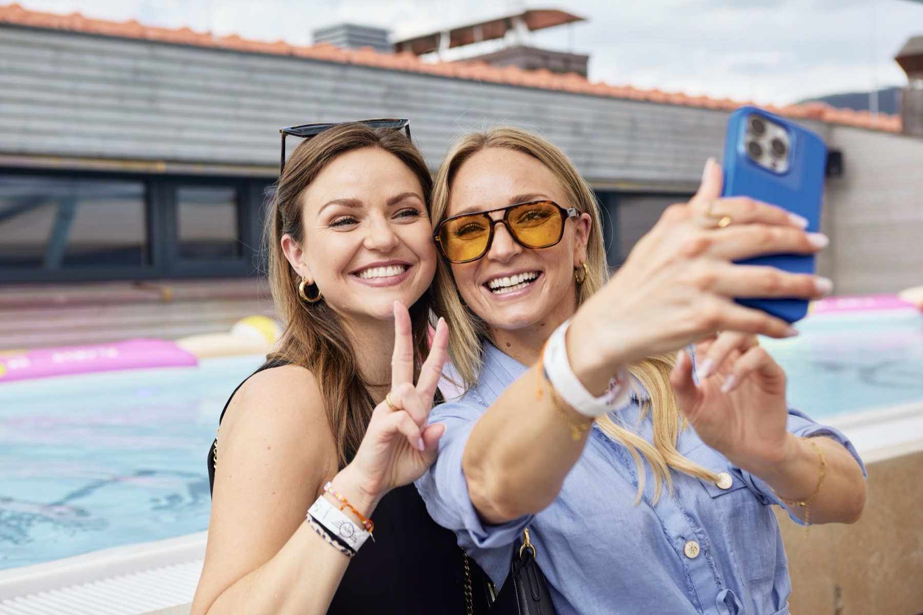 Zwei Frauen machen ein Selfie am Pool